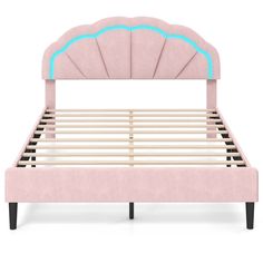 a pink bed frame with an arch shaped headboard and foot board, in front of a white background