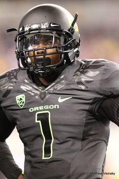 a football player wearing a black uniform and helmet