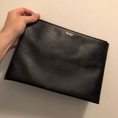 In Great Shape Designer Textured Leather Clutch For Everyday Use, Designer Black Top Handle Pouch, Luxury Black Top Handle Pouch, Designer Black Pouch For Everyday, Black Leather Top Handle Pouch, High-end Black Clutch For Everyday Use, Designer Everyday Pouch Clutch, Designer Leather Top Handle Pouch, Designer Clutch Pouch For Everyday