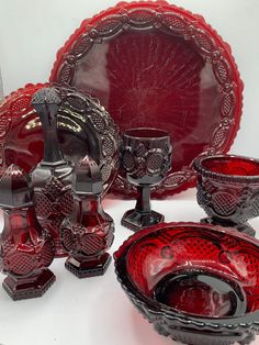 an assortment of red glass items on display