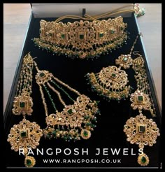 an assortment of gold jewelry on display in a black box with the words rangposh jewels