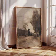 an empty room with a painting hanging on the wall next to a white drapes