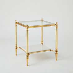 The Medford Tables feature a two-tiered design with luxurious white marble and tempered glass in a polished brass frame  perfect for both entertainment and storage. Dimensions Overall 20"L x 20"W x 22.75"H (56 lbs)  Finish Shiny Brass Shiny Brass Clean glass with professional glass cleaner; Dust with a soft, dry cloth Glass is clear tempered 8 mm thick Glass Side Table, Small Nightstand, Brass Side Table, Glass Side Tables, New Condo, Global Views, Brass Table, Glass Cleaner, Brass Frame