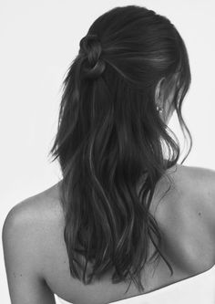 a woman with long hair wearing a strapless top