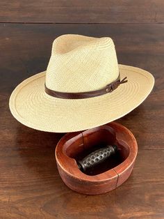 Wide brim fedora panama hat made in natural straw in natural color. Finished with an eco leather belt. Beautiful summer hat for men and woman. The measurements in centimeters are 36 x 34. Brim length 9.5. (These measurements may vary slightly depending on the size of the hat) For its elaboration we only use hoods and capelines of resistant natural straw (genuine paja toquilla) of very good quality. In our workshop in the Pyrenees we sew and make one by one our hats with wooden molds of our own d Country Style Straw Hat With Short Brim For Travel, Country Style Fedora Straw Hat For Travel, Country Style Short Brim Straw Hat For Travel, Straw Panama Hat With Curved Brim, Classic Wide Brim Straw Hat For Outdoor, Country Style Wide Brim Panama Hat For Travel, Beige Toquilla Straw Fedora Panama Hat, Western Wide Brim Panama Hat In Palm Leaf, Adjustable Wide Brim Panama Hat In Palm Leaf