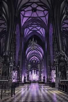 the inside of a large cathedral with chandeliers and checkered tile flooring