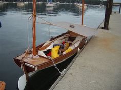 a small sailboat tied up to the dock