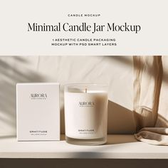 a white candle sitting next to a box on top of a table with the words minimal candle jar mockup