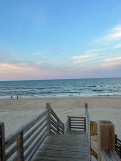 a wooden walkway leading to the beach