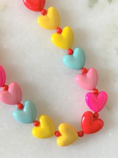 "Kids Brite Multi Colored Plastic Heart Necklace with Red Mini Spacer Beads Gold Tone Spring Ring Clasp Closure Brite Multi Hearts are Red, Hot Pink, Pink, Aqua, Yellow Hearts Measure 5/8\" Wide Necklace Measures 15\" Imported COMPLIMENTARY DOMESTIC SHIPPING" Yellow Hearts, Yellow Heart, Colorful Heart, Pink Pink, Red Hot, Spacer Beads, Spring Rings, Heart Necklace, Multi Colored