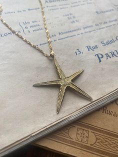 A detailed large starfish necklace. The starfish is raw brass and measures 4.3 cm. Hung on a gold-plated over stainless steel twisted chain measuring 18 inches. Comes in a black velvet cushioned box, free of charge. INTERNATIONAL BUYERS please choose the tracking option if you would like your order to be tracked. FREE tracking upgrade with 3 items or more purchased. JEWELLERY CARE please don't wear plated jewellery in the shower, bath or swimming for the plating to last longer. Silver Starfish Necklace, Ocean-inspired Starfish Charm Necklace Gift, Vacation Ocean-inspired Starfish Charm Necklace, Summer Ocean-inspired Necklace With Starfish Charm, Elegant Star-shaped Necklace With Starfish Charm, Starfish Necklace, Jewelry Lookbook, Velvet Cushions, Raw Brass