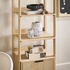 a shelf with books and vases on it