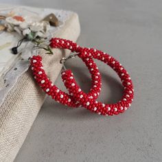 Stylish red and white polka dot beaded hoop earrings. ♥ SIZE (approximately diameter) : 1.1 inch 1.4 inch 1.6 inch 2.2 inch  ♥ 100% handmade ♥ Packed in gift box ♥ Very light ♥ If you like this item in a different color - send me a message, please. Feel free to communicate with me Advice on use and care * Never wear any jewelry while bathing or showering. Chlorine can cause damage. Please do not swim and did not take a shower in beaded jewelry * Try to avoid the drop, shock and compression of jewelry from beads Since this is handmade item, every new good may be vary slightly, but the overall look will match that shown on the photo. You can see more hoop earrings in my shop https://www.etsy.com/shop/IvonaHMJewelry?ref=seller-platform-mcnav&section_id=22254200 Summer Hoop Earrings With Tiny Beads For Gift, Small Hoop Beaded Earrings With Spacer Beads For Gifts, Gift Dangle Hoop Earrings With Spacer Beads, Small Hoop Beaded Earrings With Spacer Beads As Gift, Gift Hoop Beaded Earrings, Summer Gift Hoop Earrings With Tiny Beads, Beaded Circle Jewelry For Gifts, Beaded Circular Jewelry Gift, Hoop Earrings With Spacer Beads For Gifts