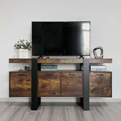 a flat screen tv sitting on top of a wooden cabinet