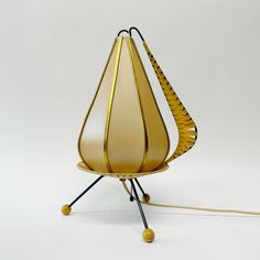 an unusual lamp is sitting on top of a stand