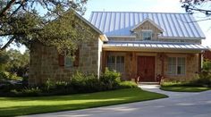 a stone house with a metal roof