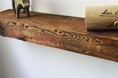 a roll of toilet paper sitting on top of a wooden shelf