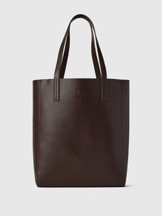 Smooth synthetic leather tote bag.  Shoulder straps at top.  This product was made in a factory that runs the Gap Inc.  P. A. C. E.  Personal Advancement & Career Enhancement) program.  P. A. C. E.  is our educational program that helps the women who make our clothes build the skills, knowledge, confidence & resilience needed to advance in work & life.  Learn more here.  Dimensions: 15"H x 12. 2" W x 5. 1" D Cheap Office Bags With Zipper Closure, Affordable Leather Bags For Back To School, Cheap Collegiate Bags For Everyday Use, Big School Handbags, Cheap Brown Tote Bag, Cheap Student Tote Shoulder Bag, Cheap Student Laptop Bag, Cheap Leather Tote Bag, Cheap Leather Shoulder Bag For Students