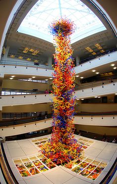 a very tall glass sculpture in the middle of a building