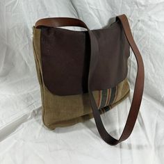 Measurements are 14" wide, 13" high, 2"5 deep, 42" shoulder strap with a 19" drop. There are two large main compartments with one exterior pocket, two tone leather, canvas and front flap.  Bag is made of canvas with stripes and bag can be used crossbody. This lovely bag by Walid is a great find with heavy wear, tears, some holes and is heavily distressed. Please look at pictures closely as bag is as pictured and shows heavy wear which gives it its rustic charm.      ----------------------------------------------------I SHIP WORLDWIDE------------------------------------------------- I want to stress that item is vintage which means it's not new. All my customers are very important to me and I believe communication is very important. I do not sell or encourage any one to sell fakes.  Not res Brown Leather Messenger Bag, By Walid, Leather Messenger Bag, Leather Messenger, Messenger Bags, Flap Bag, Rustic Charm, Messenger Bag, Brown Leather