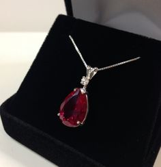 "Beautiful Ruby & White Sapphire Pendant Necklace * 7.5ct Pear Cut Ruby Measures 15mm x 10mm * Single Brilliant Cut White Sapphire Accent * 18\" Sterling Silver Chain Included * 14k White, Yellow or Rose Gold - Select your Gold color Hallmarked & Gift Ready! Matching Earrings & Ring Available This Gorgeous 7.5ct Ruby is laboratory grown. It is identical to the natural stone in every way, including chemistry, composition and hardness, with an outstanding cut, clarity and color refract Sapphire Necklace Pendants, Ruby Pendant, Fine Art Jewelry, Ruby Necklace, Rose Gold Pendant, Sapphire Pendant, Ruby Jewelry, Girly Jewelry, Diamond Pendant Necklace