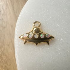 Whether you're a 👽 believer or not, this mini mothership charm is too cute to pass up. Wear it on it's own or on a jumble alongside your favorite charms on a necklace, bracelet, or strung upon hoops. Charm measures 6mm x 12mm. Simulated opal. Comes with a removable oval jump ring. Our materials make for an amazing, high quality, seamless, jewelry piece with longevity. Our rings are plated with 18k gold, 18k rose gold, or sterling silver and finished with a protective coating. A little secret we Mood Ring, Photo Template, Charm Gift, Jump Rings, Necklace Bracelet, 18k Rose Gold, Ring Necklace, Personalized Jewelry, Locket