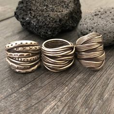 Three unique and powerful statement rings. The 3 of them are made in a braided, overlapping style that creates this unique chunky silver rings. Perfect everyday rings, that will rock your outfits, and are easy to match any other accessories. In one of the pictures, you can see which number represents each ring. Ring 1 is a size 8.5 Ring 2 is a size 8 Ring 3 is a size 8 All unique addition to your ring collection. To see more unique silver rings, click the link below https://www.etsy.com/shop/Aka Handmade Adjustable Wide Band Stackable Rings, Handmade Unique Rings With Thick Band, Unique Handmade Rings With Thick Band, Bohemian Hand Wrapped Metal Rings, Bohemian Hand Wrapped Open Ring, Bohemian Style Hand Wrapped Open Ring, Handmade Wide Band Metal Ring, Unique Handmade Wide Band Rings, Unique Wide Band Metal Rings