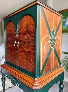 an ornate wooden cabinet with green trim and gold accents