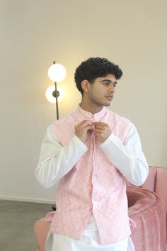 Meet Shehzaan! This is a complete 3-piece mens set perfect for any Indian event you need to attend. Features a blush pink vest on georgette base with floral and machine embroidery. Paired with a white kurta set. Looks good on its own or paired with any vest in your closet. Kurta, vest, and pants included. Formal Pink Kurta With Naqshi Detailing, Spring Wedding Nehru Jacket With Dabka, Designer Pink Kurta With Resham Embroidery, Spring Wedding Pink Nehru Jacket, Pink Fitted Set With Naqshi Detailing, Pink Sherwani For Spring Festivals, Fitted Pink Sets With Naqshi Detailing, Fitted Bollywood Style Pink Nehru Jacket, Elegant Pink Nehru Jacket For Festive Occasions