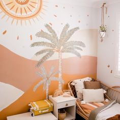 a bedroom with a palm tree painted on the wall next to a bed and dresser