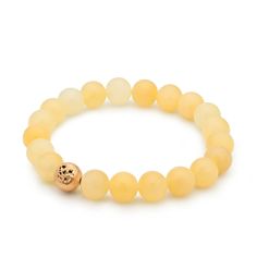 A 24ct gold plated brass pearl with a rustic surface is hidden among the pastel yellow minerals of the Honey Calcite Bracelet, giving it a special overall effect. In addition to the pleasant harmony of colors, honey calcite offers benefits such as energizing and boosting self-confidence.  The bracelet consists of 22 pearls, and thanks to its flexible design, it fits perfectly on an average female wrist.  The bracelet is handmade in our Budapest studio. MATERIAL: 24 carat gold-plated brass, honey Elegant Yellow Gemstone Beads Bracelets, Elegant Yellow Bracelets With Gemstone Beads, Elegant Yellow Beaded Bracelets With Gemstone Beads, Elegant Yellow Gemstone Beaded Bracelets, Gold Citrine Gemstone Bracelets, Adjustable Gold Citrine Bracelet, Gold Citrine Round Beaded Bracelets, Adjustable Gold Beaded Citrine Bracelet, Elegant Gold Agate Bracelets