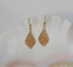 Intricate 31 x 16mm matte gold plated brass filigree teardrops dangle from 18mm gold plated brass angular ear wires. The overall drop length is 1-3/4 inches.  A travel pouch and gift box are included with every purchase. #1805 Gold Plated Filigree Teardrop Jewelry, Teardrop-shaped Gold Plated Filigree Jewelry, Gold Teardrop Earrings With Intricate Design, Gold Teardrop Earrings With Intricate Design As Gift, Gold Hypoallergenic Brass Teardrop Earrings, Hypoallergenic Gold Teardrop Brass Earrings, Hypoallergenic Gold Teardrop Earrings In Brass, Gold Teardrop Pendant Earrings With Ear Wire, Gold-plated Hypoallergenic Teardrop Earrings