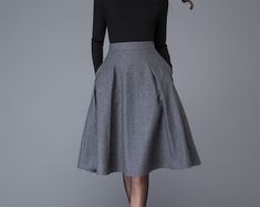 Fitted A-line Skirt For Winter, Fall Gray Skirt With Pockets, Gray Lined Skirt For Winter, Relaxed Gray Skirt For Winter, Gray Knee-length Fall Skirt, Gray Skirt For Fall, Elegant Gray Pleated Skirt For Fall, Fitted Gray Skirt For Fall, Elegant Gray Skirt With Pockets