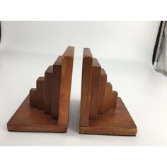 pair of wooden bookends made out of wood and metal, on white background