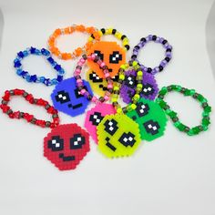 Listing is for 8 alien perler Kandi bracelets, all in a different color which includes semi-transparent and sparkly Perler beads! These super cute aliens are Perfect for stacking and sharing. Be all the rave, at the rave. Bracelets made of plastic pony beads, clear elastic chord, and finished with metal crimp beads to ensure the most possible security and avoiding the possibility of a knot becoming untied (so you can dance your nights away with your unique Kandi staying in tact!). Pendants made with Perler beads. Your item will ship out within 3 to 7 business days unless otherwise stated (i.e. during holidays or sickness). If you have a time sensitive reason for purchase, please let me know and I would be happy to help figure something out. Check me out on instagram for shop and project up Beaded Rave Bracelets For Gifts, Colorful Beads Rave Style Beaded Bracelets For Gifts, Handmade Plastic Novelty Beaded Bracelets, Handmade Novelty Plastic Beaded Bracelets, Fun Plastic Jewelry For Friendship, Handmade Stretch Bracelet For Rave Gift, Rave-style Beaded Stretch Bracelet As Gift, Handmade Rave Stretch Bracelet As Gift, Handmade Stretch Bracelet For Gift