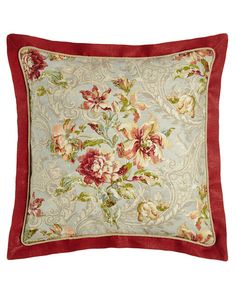 a red and white floral pillow on a white background with an embroidered flower design in the center