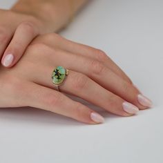 This lovely ring features a smooth, oval, green turquoise, veined with delicate, intriguing inclusion patterns. The stone is wrapped in warm 22k gold and accented with a pair of sparkling diamonds set in 22k gold. Sterling silver back and 2mm hammered band. Setting measures approximately 3/8 inch x 5/8 inch. Matte finish. Hammered Band, Lovely Ring, Green Turquoise, Sparkle Diamonds, 22k Gold, Turquoise Ring, Blue Green, Ring Size, Diamonds