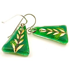 Shop Now at MyAmericanCrafts for these vibrant Leaf Triangle Earrings by Momo Glassworks. Handcrafted Fused Glass Jewelry using Mineral and Metal Oxides to create beautiful handmade images. Leaf is part of the FLORA&FAUNA collection. A stunning combination of nuanced green oxides, silvery leaves of mica, and up-cycled copper wire confer an organic spirit of nature and growth to this design. Nature-inspired Green Jewelry With Ear Wire, Nature-inspired Green Jewelry With Matching Earrings, Botanical Green Jewelry With Ear Wire, Green Botanical Drop Earrings Jewelry, Artsy Green Earrings For Gift, Unique Green Nickel-free Earrings, Artisan Green Earrings With Artistic Design, Nature-inspired Green Teardrop Earrings, Unique Green Artistic Jewelry