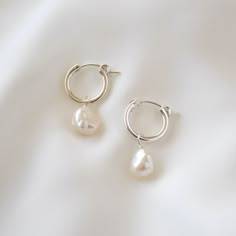 Sleek and subtle, these hoop earrings showcase the irregularities and organic form of these keshi pearls. Made of sterling silver and genuine freshwater pearls. Hoop measures 15mm in diameter while pearls measure 7-9mm in diameter. --------------------♥ PROMOS ♥-------------------- Want 10% off? Join the mailing list by visiting http://bit.ly/vedern . Just leave me a note at checkout if you have any problems applying discount codes. --------------------♥ BUY WITH CONFIDENCE ♥-------------------- Silver Earrings With Pearls, Silver Earrings Pearl, Dainty Silver Earrings Aesthetic, Pearl And Silver Earrings, Minimal Silver Earrings, Pearl Earring Ideas, Pearl Drop Earrings Silver, Silver Earrings Aesthetic Simple, Sterling Silver Hoop Pearl Earrings