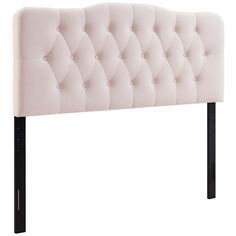 a white headboard with black legs and buttons