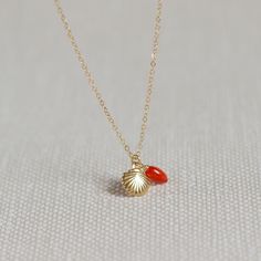 The delicate gold necklace has a cute shell pendant made of gold and a small coral pearl in red. This makes this necklace the ideal accessory for the summer.  A small gold pendant made of 14k gold fill hangs on the very fine and allergy-free chain and is very light, just like the real coral bead. The necklace is very comfortable to wear and can be combined layered with other necklaces.  Wear the dainty and elegant gold necklace with an airy summer dress, with a simple shirt and linen pants or wi Small Gold Pendant Designs, Necklace Aesthetic Gold, Aesthetic Gold Necklace, Small Gold Pendant, Elegant Gold Necklace, Jewelry Necklace Simple, Necklace Aesthetic, Aesthetic Gold, New Gold Jewellery Designs