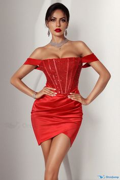 a woman in a red dress posing with her hands on her hips