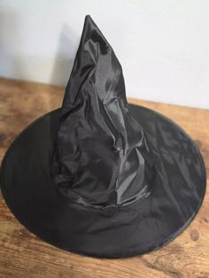 This is a costume party Halloween witch hat base that can be easily decorated or worn as is for a more classic witch look. Lightweight so ideal for lightweight decorations. THE PICTURES OF THE PREMADE HATS ARE FOR REFERENCE ONLY THEY ARE HATS I'VE MADE IN THE PAST. SO PLEASE DON'T EXPECT TO GET A PREMADE HAT. I added structure to the underside of the hat before decorating because this is a super lightweight hat. Approximately: 15 inches across the rim, 8 inches across center opening and 13 inche One Size Fits Most Costume Accessories For Halloween Cosplay, One Size Fits Most Costume Accessories For Cosplay Halloween, One Size Fits Most Halloween Cosplay Accessories, Halloween Costume Hat One Size Fits Most, Halloween Themed Hat Costume Accessories, Halloween Costume Hat For Themed Events, Halloween Costume Accessories For Costume Party, One Size Halloween Costume Accessories, One Size Fits Most Costume Accessories For Halloween