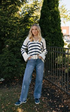 This sweater runs true to size with an oversized fit, model wearing size small. Cotton Sweater For Day Out In Fall, Cotton Sweater For Fall Day Out, Casual Cozy Fit Cropped Sweater With Ribbed Cuffs, Casual Oversized V-neck Sweater For Fall, Relaxed Knit Tops For Fall, Sporty Knit Sweatshirt For Fall, Casual White Cropped Sweater With Ribbed Cuffs, Casual Soft Knit V-neck Sweater For Spring, Casual Cropped Sweater In Relaxed Fit