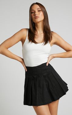 Give off major sporty and trendy vibes in the Cailin Pleated Skirt! This mini tennis skirt is a staple piece that you need in your wardrobe. It has a flattering high-waist fit and is perfect to wear all year 'round for any occasion. You can dress it up with a crop top and heeled sandals, or down with an oversized tee, chunky sneakers and a 90s mini bag!Product DetailsInvisible side seam zipperPleated detailNo liningNo pocketsSize & FitSize 8 length: 41cm / 16.1inModel is wearing size 8 AU / Black Summer Skirt Outfit, Sporty Mini Tennis Skirt For Spring, Sporty Mini Length Skort With Lined Skirt, Sporty High Waist Pleated Skort, Sporty High Waist Pleated Tennis Skirt, Sporty Mini Length Tennis Skirt With Lining, Sporty Mini Length Lined Tennis Skirt, Spring Casual Mini Skirt Tennis Dress, Sporty Mini Skort With Lined Skirt