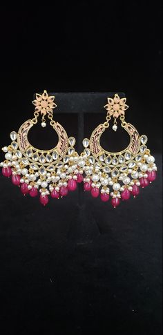 "This beautiful Kundan earrings set has an excellent finish and gives out an exquisite sense of style. If you are looking for an amazing Fashion Jewelry set for special occasions such as Anniversary, Engagement, Party, Wedding, gifting, then your search ends here. This handmade Indian Jewelry is best to wear for traditional ceremonies or Indian weddings. This bridal jewelry has an ethnic finish. It has Cubic Zircon stones with semi-precious ruby and emeralds. It is a Bollywood style one-gram jew Festive Fusion Dangling Beads Earrings, Traditional Chandbali Earrings With Dangling Beads, Traditional Chandbali Jewelry With Dangling Beads, Festive Fusion Danglers With Dangling Beads, Elegant Kundan Danglers With Dangling Beads, Elegant Kundan Danglers With Beads, Elegant Chandbali Beaded Earrings For Festivals, Traditional Dangling Beads Earrings For Celebration, Traditional Earrings With Dangling Beads For Celebration