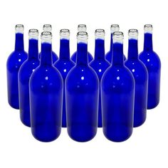 blue glass bottles are lined up in a row