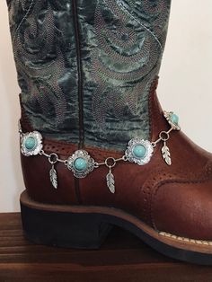 Beautiful hand crafted boot jewelry. These are faux  silver with boho turquoise colored stones. Faux silver feathers dangle in between the conchos. This boot bracelet  has Lobster clasp.   This is a Unique style not to be found anywhere but Old hands Creations! This one is 15" in total length. Check out our chain belts and if you purchase more that one item you can save 20%. Please check out our other items as some are complimentary to this item. If you buy 2 or more items you will get 20% off! We take custom order requests as well. Boot Accessories Jewelry, Boots Bracelets, Boot Jewelry Bling, Cowboy Boot Jewelry, Western Boot Bracelet, Boot Chains, Bridal Boots, Boot Bracelet, Boot Bling