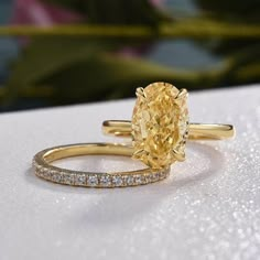 Make a statement on your special day with our Oval Cut 3.5ct Yellow Sapphire Yellow Gold Bridal Set by Evani Naomi Jewelry. This awe-inspiring set boasts an oval cut design crafted from high-quality, ethically sourced materials, creating a stunning and dazzling effect. Made from 92.5% pure silver and 7.5% hypoallergenic metals, dipped 5x in 18k yellow gold, each piece is built to last a lifetime. With round stones and a glossy finish, this elegant and affordable set provides a sophisticated look Sunshine Engagement Ring, Vintage Yellow Diamond Ring, Yellow Wedding Rings, Yellow Saphire Engament Ring, Yellow Wedding Ring, Yellow Diamond Engagement Rings, Yellow Sapphire Engagement Ring, Yellow Sapphire Ring Engagement, Citrine Rings