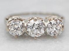 three stone diamond ring on white background